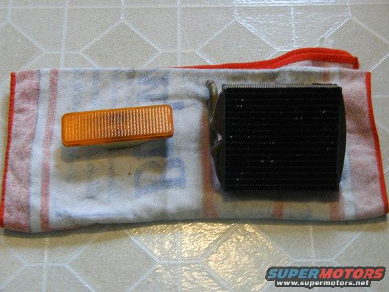 Orange rectangular turn signal and black radiator on a towel