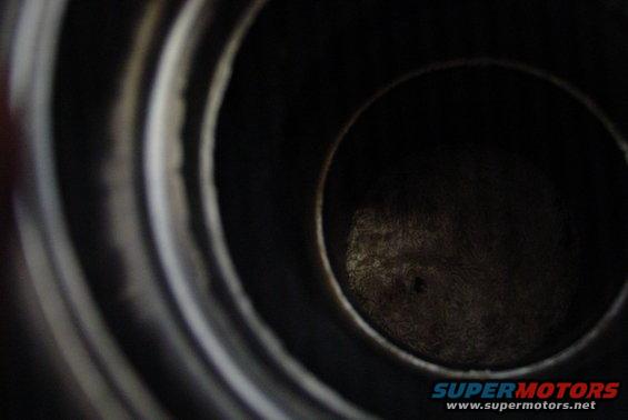 Close-up of engine cylinder interior with Supermotors.net watermark