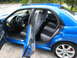 2007 Subaru Impreza - Interior and side view of a blue 2007 Subaru Impreza, showing the front and rear seats, dashboard, and steering wheel.