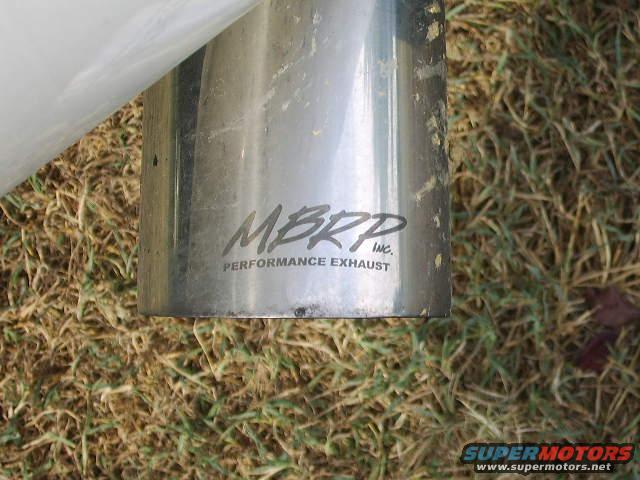 Close-up of an MBRP Performance Exhaust tip on the ground
