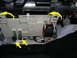 2007 Mazda 3 - Close-up of a vehicle's fuse box and wiring harness, with yellow arrows indicating specific connection points and clips.