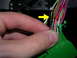 2007 Mazda 3 - A hand manipulates electrical wiring, with a yellow arrow highlighting a specific connection point in-focus wire.