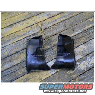 Two black plastic car fender trim pieces on a wooden surface