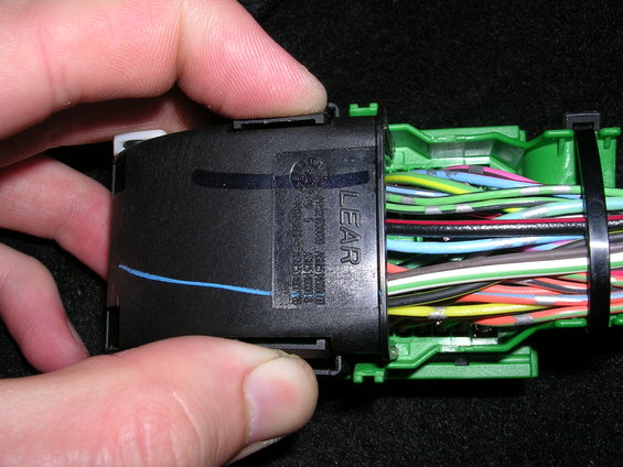 Black electrical connector with 'LEAR' logo and colorful wires