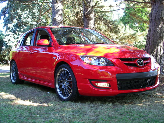 Red 2007 Mazda 3 hatchback parked outdoors