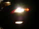 2007 Mazda 3 - The front fog lights and headlight of a 2007 Mazda 3 are illuminated at night.