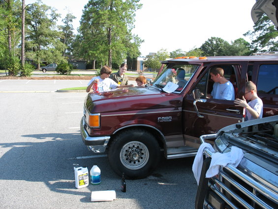1995 Ford C-150 (Centurion Conversions) with people gathered around the hood, some working on it