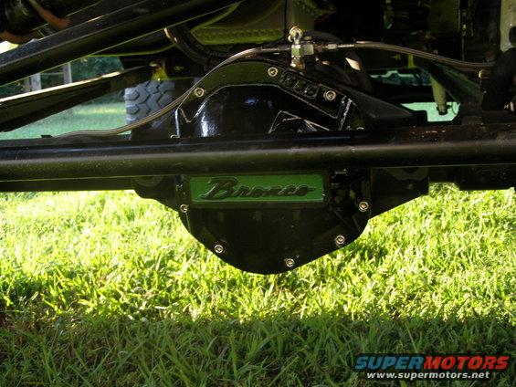 Rear differential housing with green 'Bronco' badge and visible suspension components