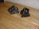 1992 Toyota Tacoma - Two custom metal brackets sit on a wooden surface.