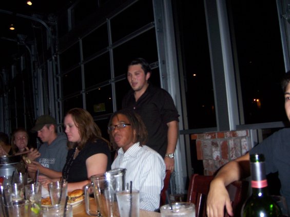 People gathered around a table with food and drinks