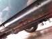 1995 Mercury Grand Marquis - The underside of a green vehicle shows significant rust damage along the rocker panel and frame.
