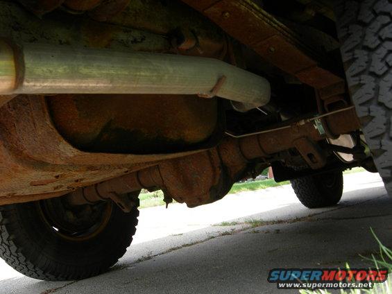 Underbody view of exhaust pipe and suspension components