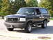 1993 Ford Bronco - A black 1993 Ford Bronco is shown from a 3/4 front angle, parked outdoors.