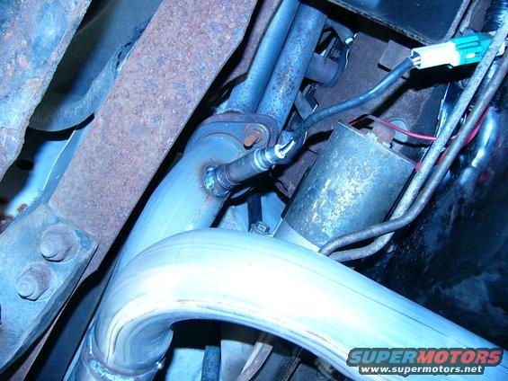 Exhaust pipe with oxygen sensor and part of starter motor