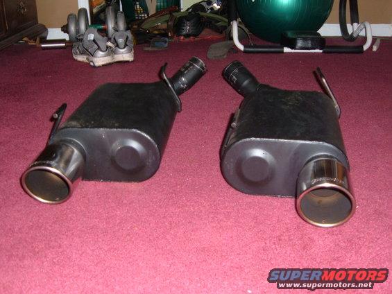 Two black exhaust mufflers with chrome tips, one on each side