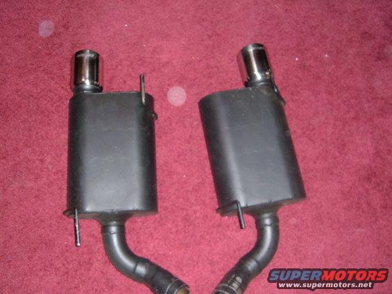pair of black exhaust mufflers with chrome tips