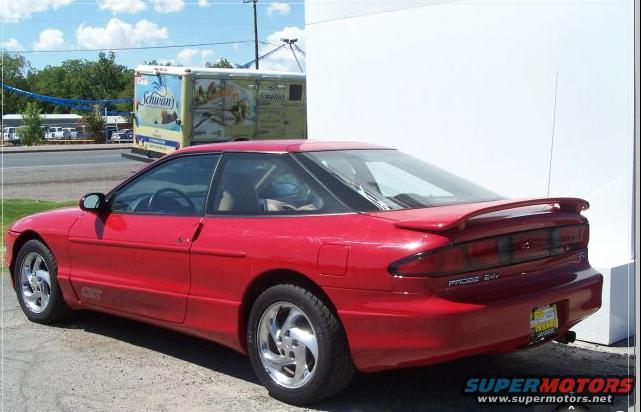 Red 1996 Ford Probe GT parked outside. Schwan's truck in background