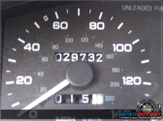 Car dashboard showing a speedometer reading 20 MPH and an odometer reading 029732. The fuel gauge shows empty