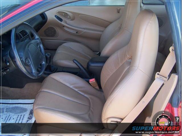 Tan leather interior with bucket seats and steering wheel