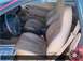 1996 Ford Probe - Interior view of a car with tan leather bucket seats and a steering wheel. Text on floor mat is partially visible.