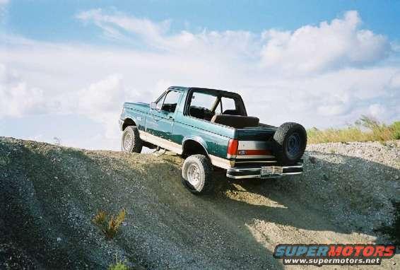 Green 1990 Ford Bronco 3q-front view on a dirt hill
