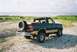 1990 Ford Bronco - Rear view of a 1990 Ford Bronco parked on a dirt and gravel area with a body of water behind it.