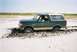 1990 Ford Bronco - This 1990 Ford Bronco is stuck deep in the mud on a sandy terrain.