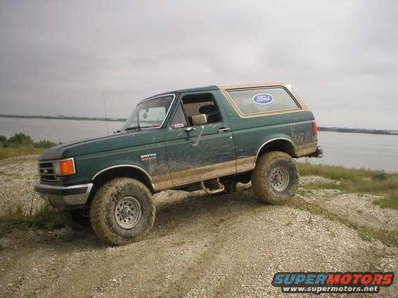 Green 1990 Ford Bronco 3/4 front view off-roading