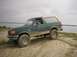 1990 Ford Bronco - This 1990 Ford Bronco is captured in a 3/4 front view as it navigates an off-road trail.