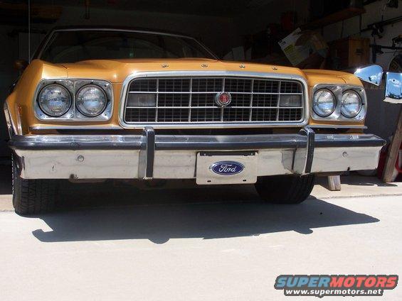 Front view of a gold 1973 Ford Ranchero with a chrome bumper and grille. Ford logo on the license plate