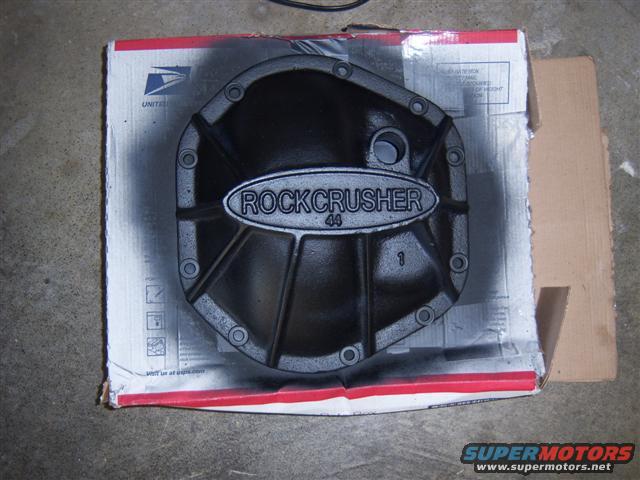 Black differential cover with "ROCKCRUSHER 44" text, on a cardboard box