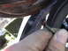 1977 Ford Mustang - A hand holds a frayed electrical wire, suggesting an electrical issue within the vehicle's interior.