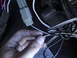 1977 Ford Mustang - Close-up of hand manipulating electrical wiring and connectors.