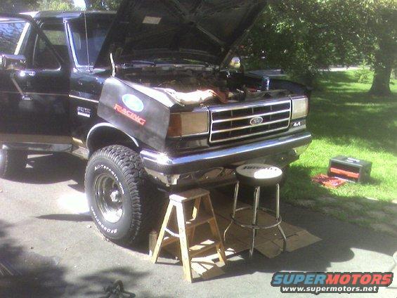 Black 1990 Ford Bronco with hood open, front view
