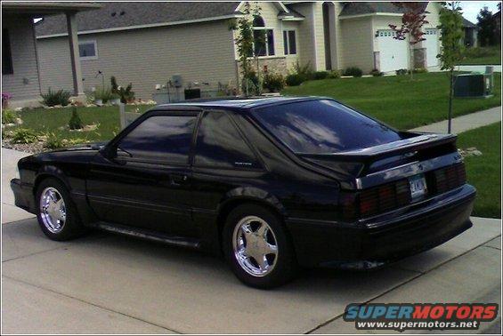 black 1989 Ford Mustang coupe parked on driveway, rear view