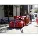2007 Ford Ranchero - A custom hot rod with a large spoiler and exposed engine is parked on a street with people around.