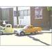 2007 Ford Ranchero - Two pickup trucks are parked in front of a building with a poster on the wall.