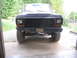 1979 Ford Bronco - Front view of a dark-colored truck, showing its grille and bumper with visible suspension components.