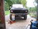 1979 Ford Bronco - Front view of a 1979 Ford Bronco undergoing maintenance, raised on a jack.