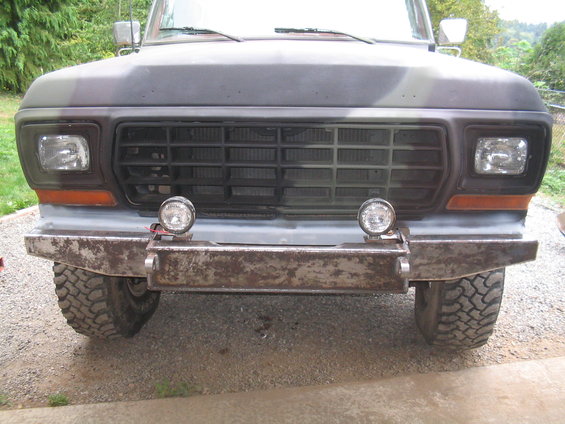 Front bumper and grille of a truck with aftermarket lights