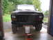 1979 Ford Bronco - The front of a black Ford Bronco is shown, supported by a jack and bucket inside a garage.