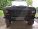 1979 Ford Bronco - Close-up view of the front bumper and grille of a truck, a camouflage pattern on the bumper.