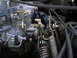 1978 Ford F-250 - Detail of the throttle linkage and return springs on a vehicle's carburetor.