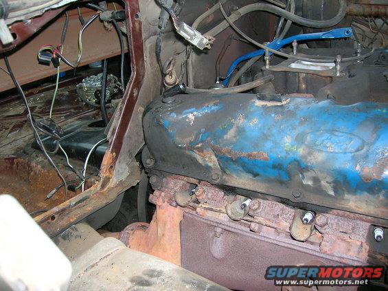 1978 Ford F-250 engine bay, blue valve covers, rusty exhaust manifold, visible spark plugs