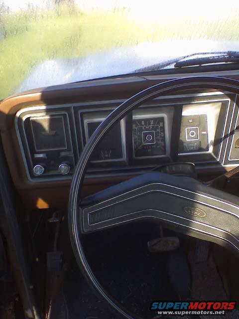 1978 Ford F-250 interior with brown dashboard and steering wheel. The instrument cluster is visible