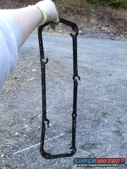 hand holding old valve cover gasket