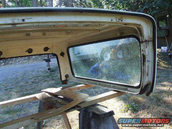 Removed hardtop of a vehicle, resting on sawhorses. Interior and exterior are visible