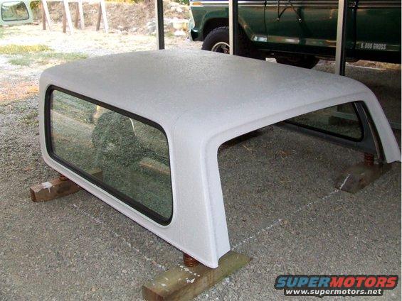 White camper shell with tinted windows