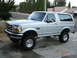 1996 Ford Bronco - This silver 1996 Ford Bronco is shown from a 3/4 front angle, highlighting its lifted suspension and overall body style.