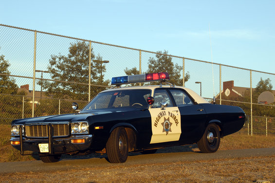 1973 black and white police car with light bar, front 3/4 view